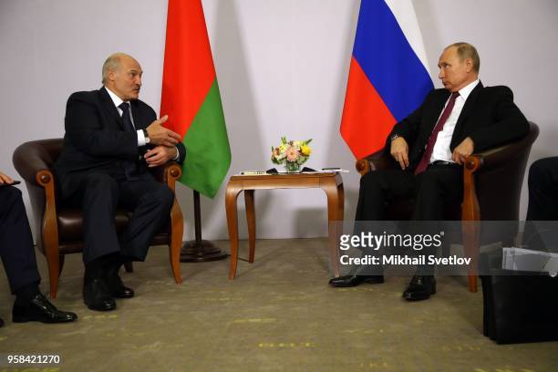 Russian President Vladimir Putin listens to Belarussian President Alexander Lukashenko during their bilateral meeting prior to the Eurasian Economic...