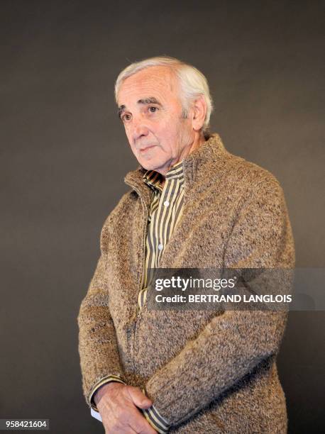 French singer Charles Aznavour performs for a clip as part of a recording, with a dozen of French rappers and pop stars, a music video to raise funds...