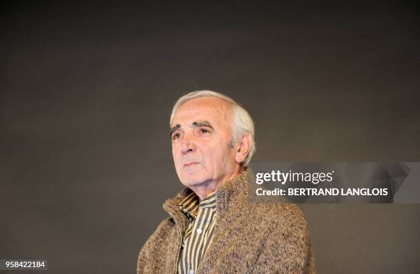 French singer Charles Aznavour performs for a clip as part of a recording, with a dozen of French rappers and pop stars, a music video to raise funds...