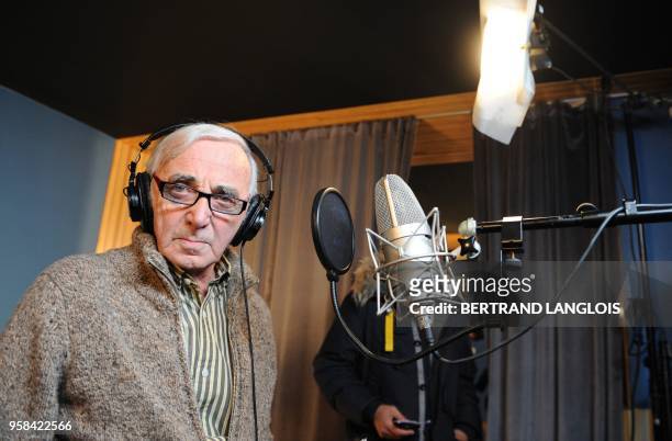 French singer Charles Aznavour poses while recording, with a dozen of French rappers and pop stars, a music video to raise funds for quake-stricken...