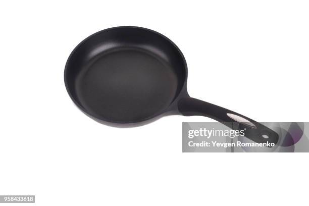 black frying pan with a non-stick teflon coating, isolated over the white background - cast iron stock pictures, royalty-free photos & images