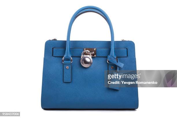 blue leather women's handbag on white background - blue purse stock-fotos und bilder