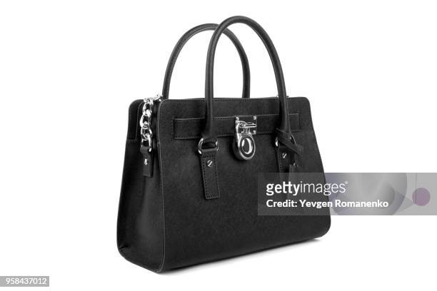 black leather women's handbag on white background - black purse fotografías e imágenes de stock