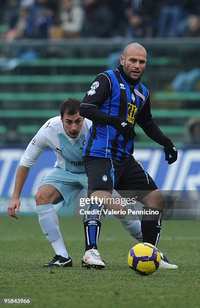 Simone Tiribocchi of Atalanta BC is challenged by Stefan Radu of SS Lazio during the Serie A match between Atalanta BC and SS Lazio at Stadio Atleti...