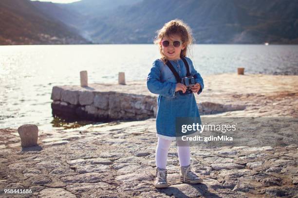 young girl on the dock taking pictures on action camera - go pro camera stock pictures, royalty-free photos & images