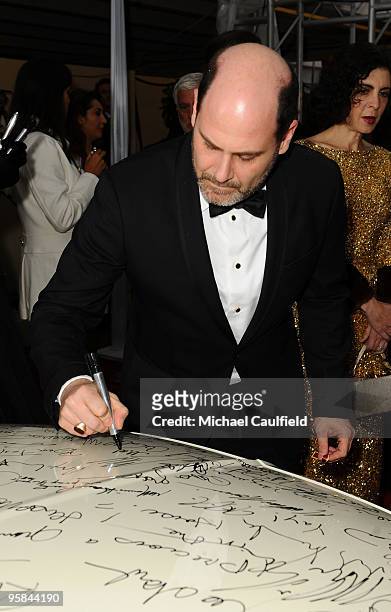 Matthew Weiner signs the Chrysler 300 Eco Style car for Stars for a Cause during the 67th annual Golden Globe Awards held at The Beverly Hilton Hotel...
