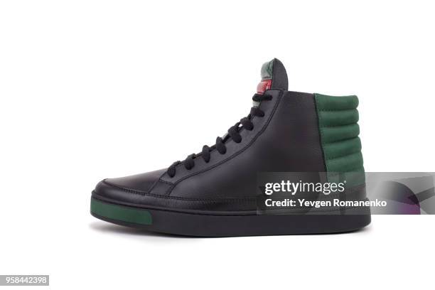 side view of black leather high-top sneaker, isolated on white background - leather training shoes stock-fotos und bilder