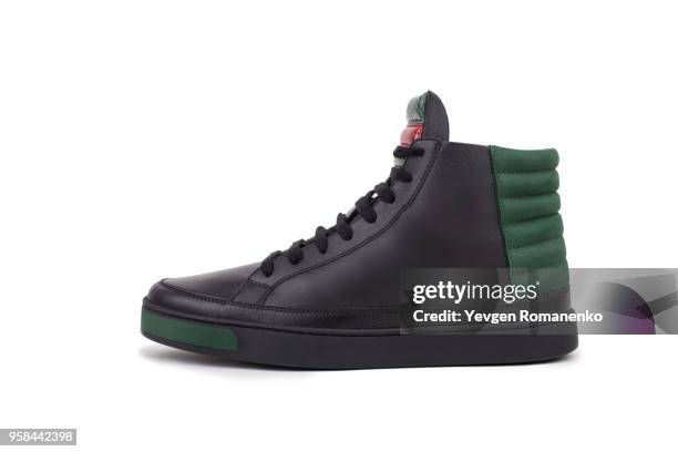 side view of black leather high-top sneaker, isolated on white background - botas de cuero fotografías e imágenes de stock