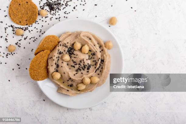chickpea hummus with black sesame seeds on top - dipping sauce stock pictures, royalty-free photos & images