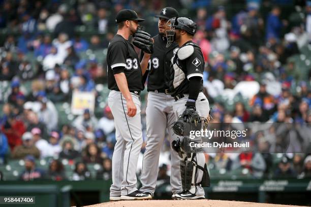 James Shields, Jose Abreu, and Welington Castillo of the Chicago White Sox meet at the mound in the first inning against the Chicago Cubs at Wrigley...