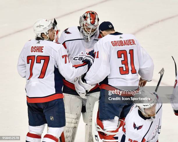 Washington Capitals right wing T.J. Oshie and Washington Capitals goalie Philipp Grubauer congratulate Washington Capitals goalie Braden Holtby after...