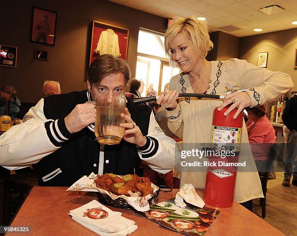 Country Artist Darryl Worley tries some of Country Artist Lorrie Morgan's Hot Chicken at the Country Crossing Grand Opening Kick-Off Celebration at...