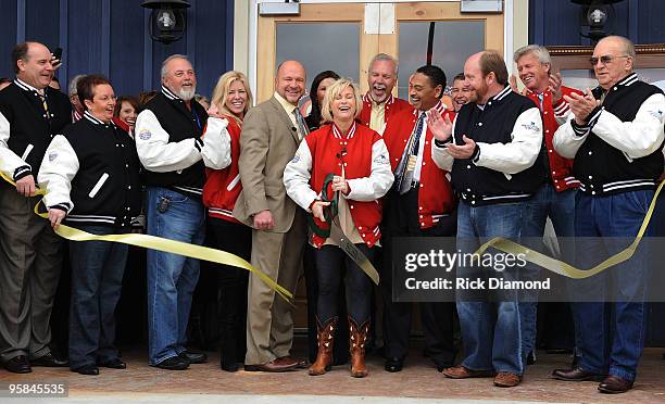 Country Artist Lorrie Morgan cuts the ribbon and opens Lorrie Morgans Hot Chicken during the Country Crossing Grand Opening Kick-Off Celebration at...