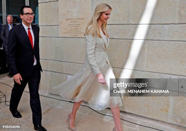 Treasury Secretary Steve Mnuchin and US President's daughter Ivanka Trump walk after unveiling an inauguration plaque during the opening of the US...