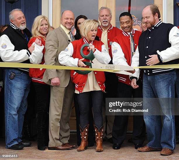 Country Artist Lorrie Morgan cuts the ribbon and opens Lorrie Morgans Hot Chicken during the Country Crossing Grand Opening Kick-Off Celebration at...