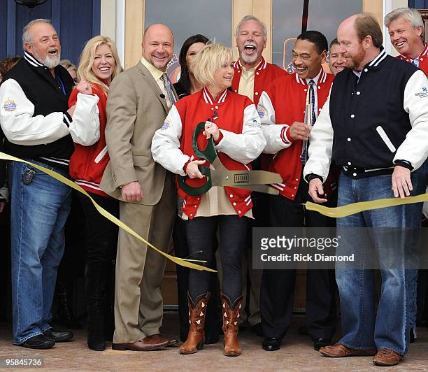 Country Artist Lorrie Morgan cuts the ribbon and opens Lorrie Morgans Hot Chicken during the Country Crossing Grand Opening Kick-Off Celebration at...