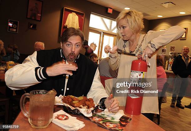 Country Artist Darryl Worley tries some of Country Artist Lorrie Morgan's Hot Chicken at the Country Crossing Grand Opening Kick-Off Celebration at...