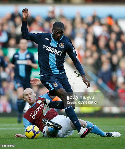 West Ham's English striker Frank Nouble vies with Aston Villa's Welsh defender James Collins during their English Premier League football match at...