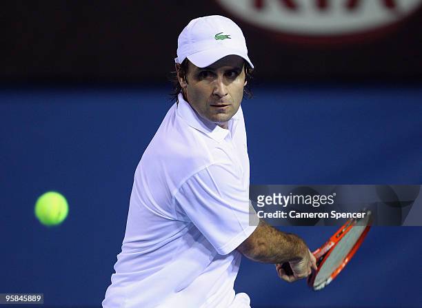 Fabrice Santoro of France plays a backhand in his first round match against Marin Cilic of Croatia during day one of the 2010 Australian Open at...