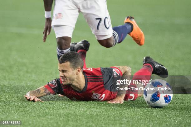 May 12: Sebastian Giovinco of Toronto FC is fouled by Cristian Penilla of New England Revolution during the New England Revolution Vs Toronto FC...