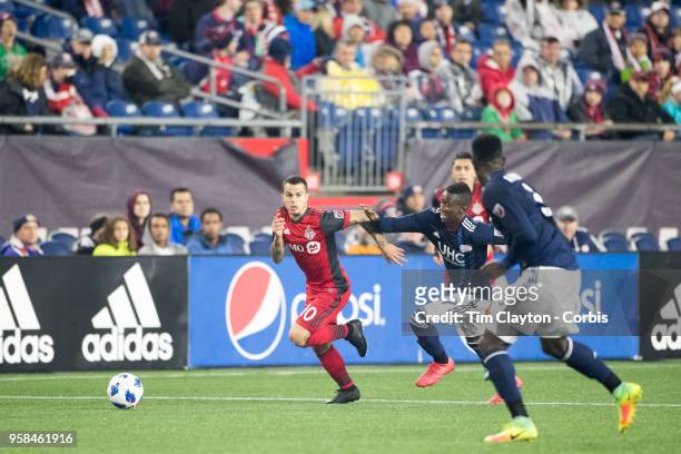 May 12: Sebastian Giovinco of Toronto FC challenged by Luis Caicedo of New England Revolution during the New England Revolution Vs Toronto FC regular...