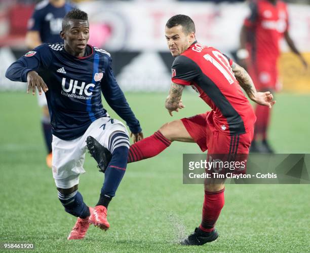 May 12: Sebastian Giovinco of Toronto FC challenged by Luis Caicedo of New England Revolution during the New England Revolution Vs Toronto FC regular...