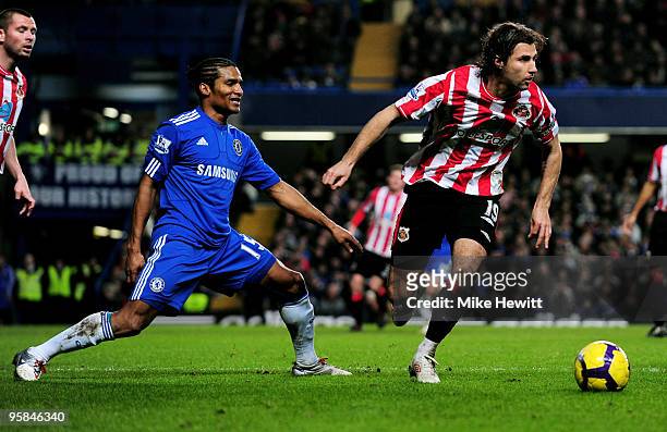 Lorik Cana of Sunderland goes past the challenge from Florent Malouda of Chelsea during the Barclays Premier League match between Chelsea and...