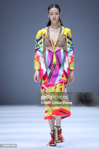 Model showcases designs on runway at Sichuan Fine Arts Institute show during China International College Student Fashion Week 2018 at 751D.Park on...