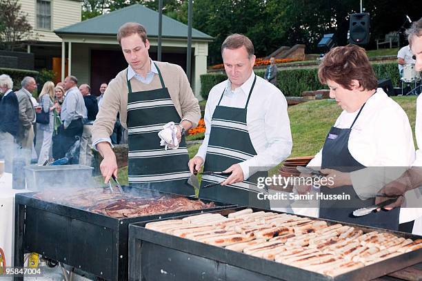 Prince William and John Key, Prime Minister of New Zealand prepare meat and enjoy a drink at a barbecue at Premiere House on the second day of his...