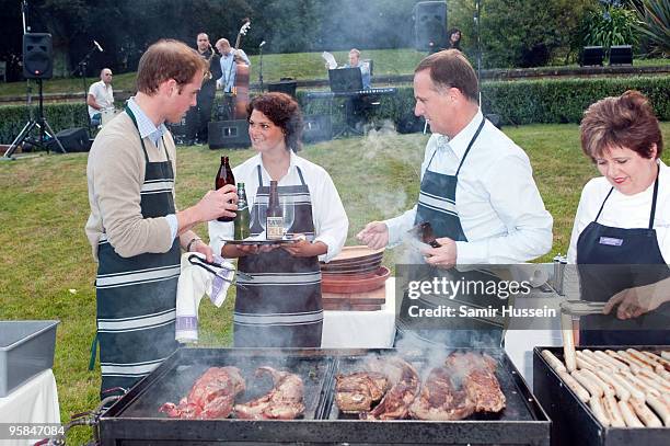 Prince William and John Key, Prime Minister of New Zealand prepare meat and enjoy a drink at a barbecue at Premiere House on the second day of his...