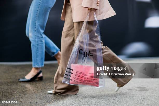 Sara Donaldson wearing grey jacket, cropped denim jeans, slingbacks and a guest wearing salmon colored blazer jacket, wide leg pants, see through...