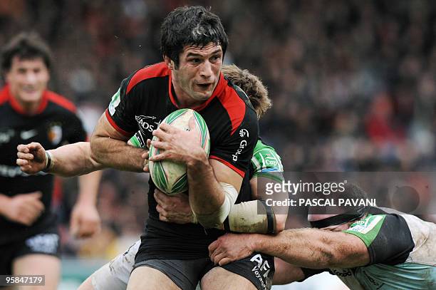 Toulouse's flanker Jean Bouilhou vies with London Harlequins' players during the European Cup rugby union match Toulouse vs London Harlequins on...
