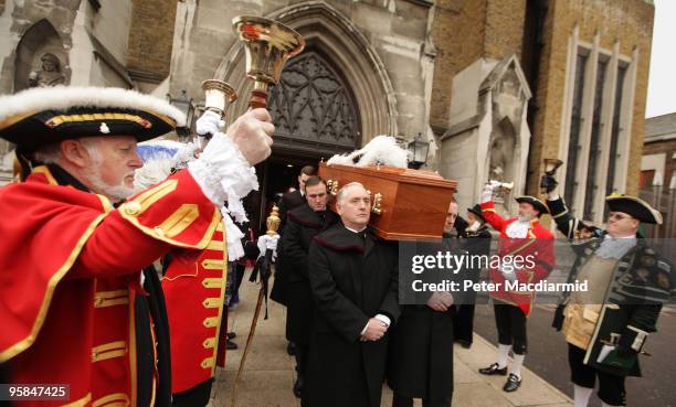 Town criers line up outside St George's Cathedral as pall bearers carry the coffin of London town crier Peter Moore after a requiem mass on January...