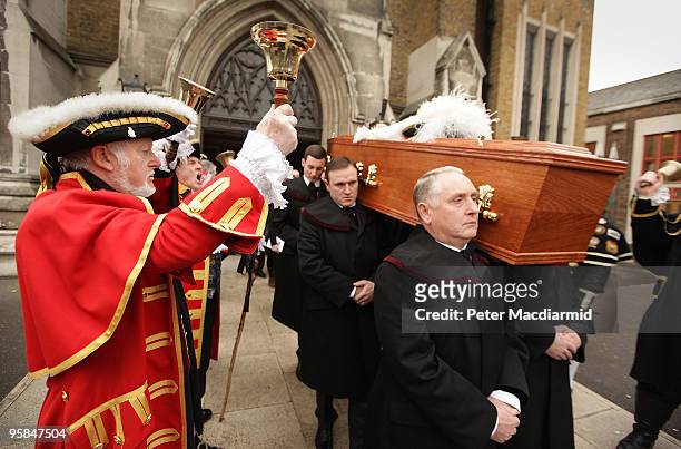 Town criers line up outside St George's Cathedral as pall bearers carry the coffin of London town crier Peter Moore after a requiem mass on January...