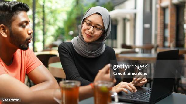 Young muslim female and male working together