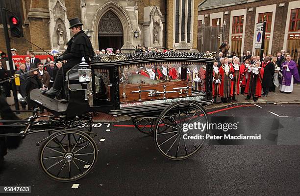 Horse drawn hearse carries the coffin of London town crier Peter Moore after a requiem mass held at St George's Cathedral on January 18, 2010 in...