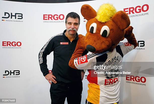 German handball national coach Heiner Brand and German handball mascot Hannibal present the new German national handball jersey during a news...