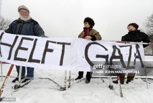 Demonstrators display a banner reading "Help Gaza" during an anti-Israel protest between the chancellery and the Reichstag building in Berlin January...