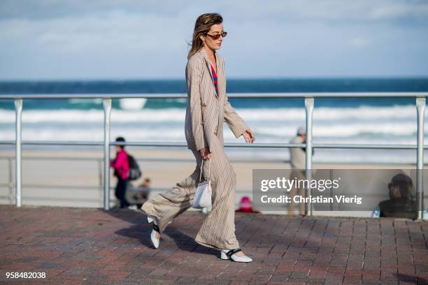 Carmen Hamilton wearing striped suit, red blue striped v neck top, sunglasses during Mercedes-Benz Fashion Week Resort 19 Collections at Bondi Beach...