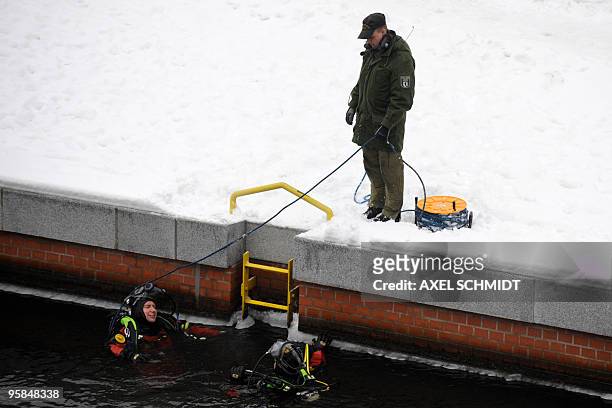 Police frogmen lower themselves into the river Spree to secure the area near the chancellery where German Chancellor Angela Merkel meets Israeli...