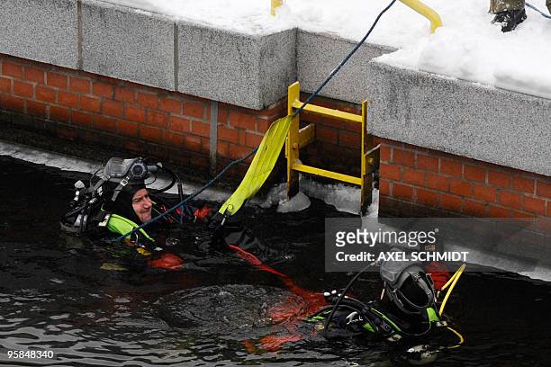 Police frogmen lower themselves into the river Spree to secure the area near the chancellery where German Chancellor Angela Merkel meets Israeli...