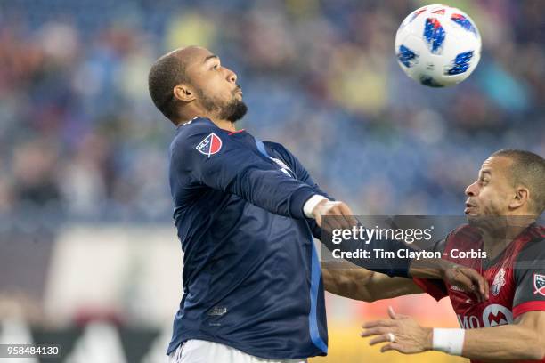 May 12: Teal Bunbury of New England Revolution is challenged by Jason Hernandez of Toronto FCtt12""in action during the New England Revolution Vs...