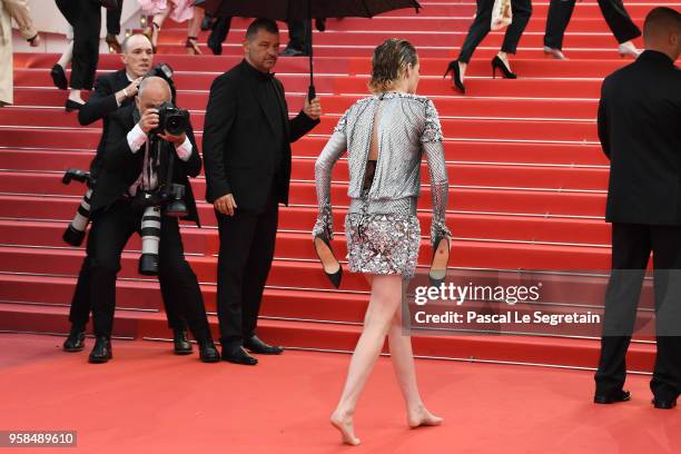 Jury member Kristen Stewart takes off her shoes as she walk the red carpet for the screening of "Blackkklansman" during the 71st annual Cannes Film...