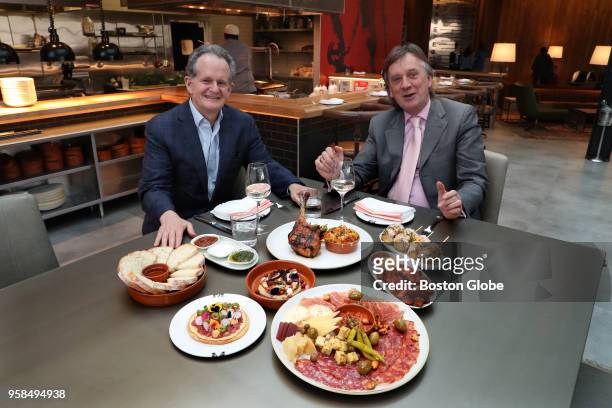 Jon Davis, left, and Robin Brown, owners of the newly-renovated Woburn Hilton, pose with a table full of dishes in their modern tapas restaurant,...