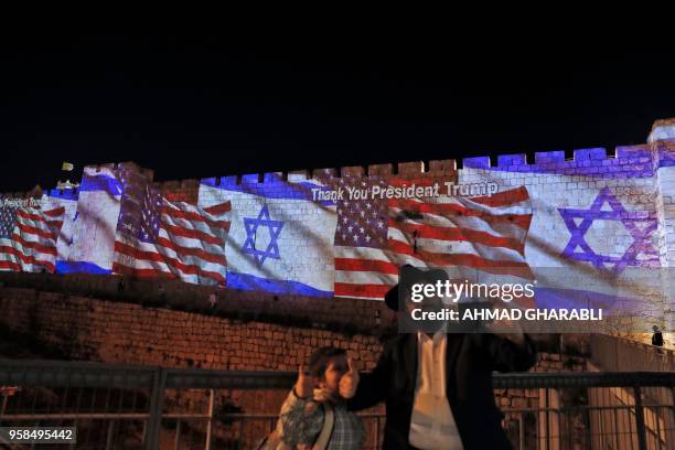 The Israeli and United States flags are projected on the walls of the ramparts of Jerusalem's Old City, to mark the opening of the new US embassy on...