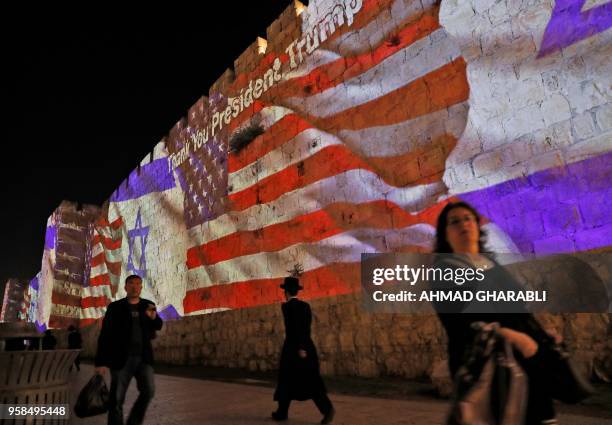 The Israeli and United States flags are projected on the walls of the ramparts of Jerusalem's Old City, to mark the opening of the new US embassy on...