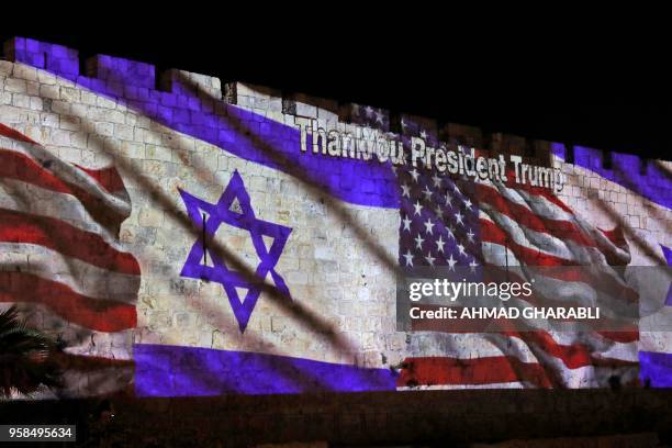 The Israeli and United States flags are projected on the walls of the ramparts of Jerusalem's Old City, to mark the opening of the new US embassy on...