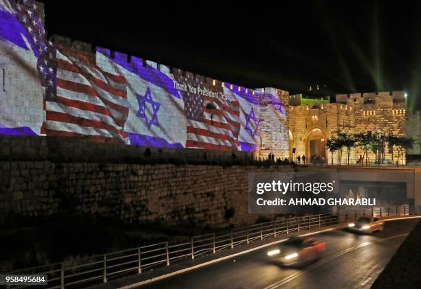 The Israeli and United States flags are projected on the walls of the ramparts of Jerusalem's Old City, to mark the opening of the new US embassy on...