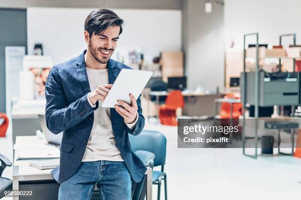 smiling designer with digital tablet - businesswear stock pictures, royalty-free photos & images