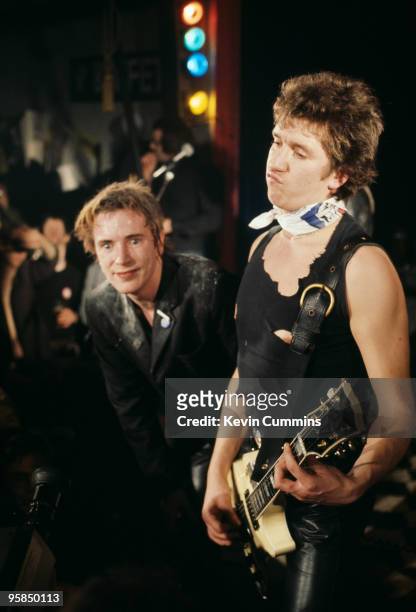 Johnny Rotten and Steve Jones of British punk band the Sex Pistols perform on stage at a free concert for the children of striking firefighters held...